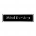 The Spectrum Industrial Room Signs Mind The Step Sign features a sleek black and polished chrome effect design. The self-adhesive PVC material ensures easy installation. Measuring 200mm by 50mm, this sign is compact yet visible.