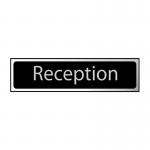 In the photo, a sleek black and polished chrome industrial room sign is shown with self-adhesive PVC material. The sign measures 200mm by 50mm and features bold lettering, making it easily visible in any reception area.