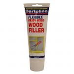 The photo shows a 330gm tube of white wood filler from Bartoline Limited Tools, labeled with product information and a logo. The tube is filled with a creamy white substance, ready to be used for filling cracks and holes in wood.