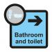 The Spectrum Industrial Directional Signs Assisted Living Sign shows a white sign with the words Bathroom and Toilet and a right-pointing arrow, with a size of 305 x 310mm. Underneath the arrow is the acronym SA FMX while the product code ALS005 rests on the bottom edge.