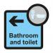 This image shows Spectrum Industrial Directional Signs Assisted Living Sign with an arrow pointing left, indicating the direction of the bathroom and toilet. The sign reads Assisted Living and is sized at 305 x 310mm. The background color is deep blue with white letters and symbols.