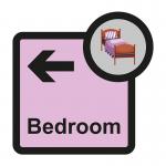 The image shows a Spectrum Industrial Directional Sign for Assisted Living. It features a bedroom arrow pointing left and is sized at 305 x 310mm. The sign is labeled as ALS042 and has the text SA FMX written on it.