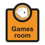 In this photograph, we see a Spectrum Industrial Room Sign for an Assisted Living facility. The sign reads Games Room - SA FMX in bold white letters against a blue background. The sign measures 266 x 310mm and has the product code ALS069 printed on the bottom.