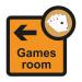 The image shows a Spectrum Industrial Directional Sign for an Assisted Living facility. It features an arrow pointing left towards a Games Room. The sign is 305 x 310mm and bears the letters SA FMX.