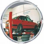The photo showcases a 400mm diameter standard security mirror from Spectrum Industrial, designed specifically for parking facilities. The mirror has a shiny surface and is mounted on a wall or pole for improved visibility and safety. Its sturdy construction and reflective surface make it an essential addition to any industrial parking area.