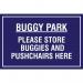 The photograph features a 400 x 300mm educational sign from Spectrum Industrial. The sign is labeled Buggy park and instructs visitors to Please store buggies and pushchairs here. The sign includes the abbreviation PP and the product code is EDU008. The sign is clear and concise, with bold and easy-to-read text. It uses the colors blue, white, and black, and features a simple graphic of a buggy. This sign is perfect for reminding guests to properly store their buggies and pushchairs.