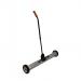 A photograph of Spectrum Industrial Brushes & Brooms 1010mm Large Magnetic Sweeper with Release MAGSW02 shows a large magnetic sweeper with a black handle and red bristles. The sweeper is being used on a concrete floor, attracting metal debris with its strong magnetic force.