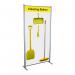 The image shows a sleek black frame with a vibrant yellow shadowboard attached to it. On the shadowboard, there are various hooks and holders displaying Spectrum Industrial Cleaning Systems & Trolleys. The cleaning station style A is neatly organized with its supplies and tools, ready for use.