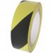 The photo shows a roll of Spectrum Industrial Quarantine Tape, featuring adhesive PVC material, designed for highlighting hazards and marking internal procedures. Its vibrant colors and reliable adhesive make it a practical tool for safety and organization.