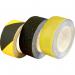 The image shows a roll of black non-slip floor tape from Spectrum Industrial. It measures 50mm wide and is 18.2m in length. The tape is designed for use in floor marking equipment and is ideal for creating safe and visible areas in industrial settings.