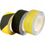The picture shows a roll of black and yellow non-slip floor tape, measuring 100mm x 18.2m, from Spectrum Industrials line of floor marking equipment. The tape is designed to improve safety in industrial settings by providing a highly visible and durable marking on floors.