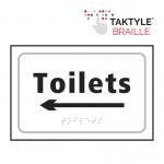 The Spectrum Industrial washroom signs are self-adhesive and feature a directional arrow pointing left. The signs are designed for toilets and are in a crisp white color. The dimensions are 225mm x 150mm.