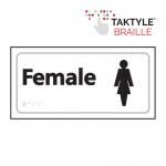 The photo shows a white Spectrum Industrial Washroom Signs Female sign with the words Female written in black, self adhesive Taktyle material. The sign has a size of 300mm x 150mm and is ideal for washroom use.