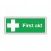 The photograph depicts a first aid sign with the dimensions of 150x110mm. The sign is self-adhesive and has EO4XS SR71218 stamped on it. It is designed to promote safety in a workplace environment.