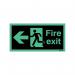 In the image, a bright red and white fire safety sign with a running man and arrow pointing left is depicted against a dark background. The words Fire Exit are clearly displayed and the sign is labeled as Niteglo for visibility in low light. It measures 150x450mm and can be self-adhesive for easy installation.