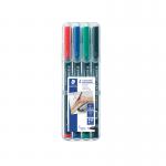 The photograph features a pack of 4 Staedtler OHP Markers in assorted colors, along with a Staedtler Lumocolour Pen Permanent Fine. The markers are neatly arranged and each has a cap on, ready for use. The Lumocolour pen is positioned beside the markers, showing its compact size.