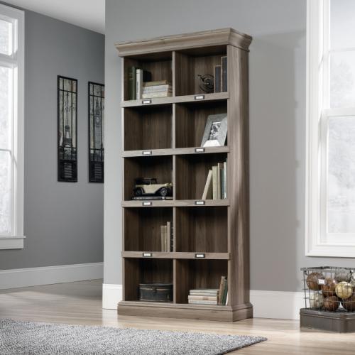 The picture shows a tall bookcase with a salt oak finish from Teknik Office. It features ten cubby holes and metal tags for labeling. The contrasting colors add a modern touch to this stylish piece of furniture.