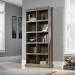 The picture shows a tall bookcase with a salt oak finish from Teknik Office. It features ten cubby holes and metal tags for labeling. The contrasting colors add a modern touch to this stylish piece of furniture.