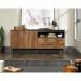 Teknik Office Boulevard Cafe TV Credenza in a black finish with Vintage Oak accents accommodates up to 60” TV 2 adjustable shelves behind doors