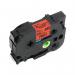 The photo shows a black on red label tape for Brother printers. The tape is 12mm wide and 8m in length, with the label TSW on it. The label is clear and easy to read, making it perfect for organizing and labeling.